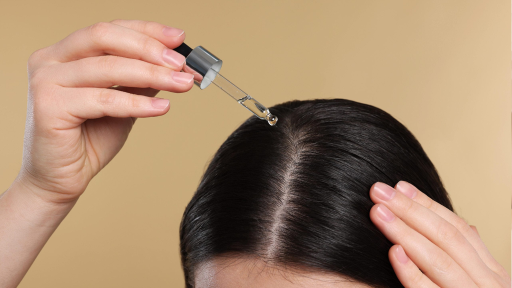 Applying hair serum directly to the scalp for nourishment and promoting healthy hair growth|yourleaf.in
